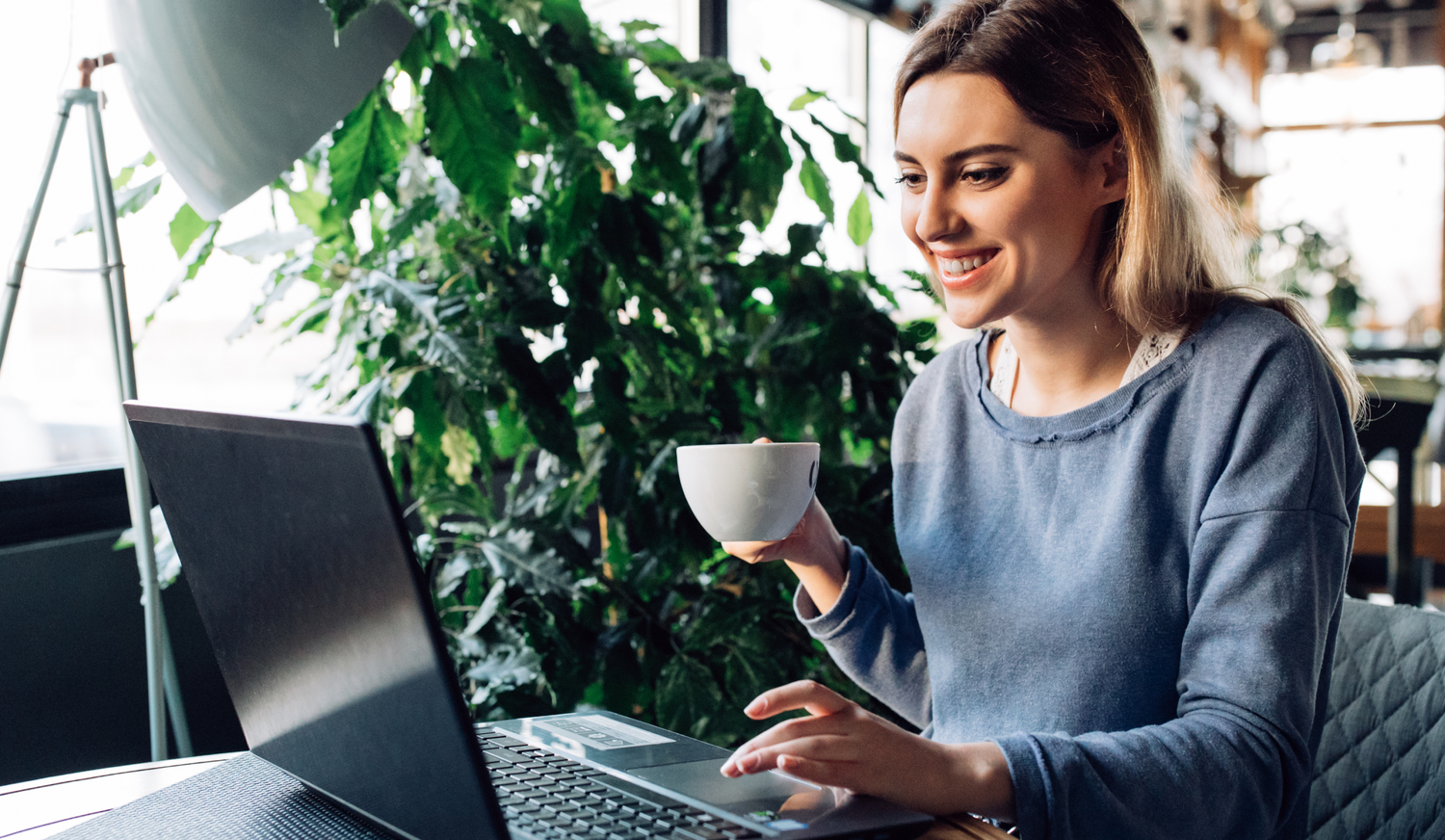 A professional customer experience ordering premium retractable banner stands on a laptop, showcasing GoVizly's hassle-free process, high-quality hardware, and fast turnaround for corporate event branding.